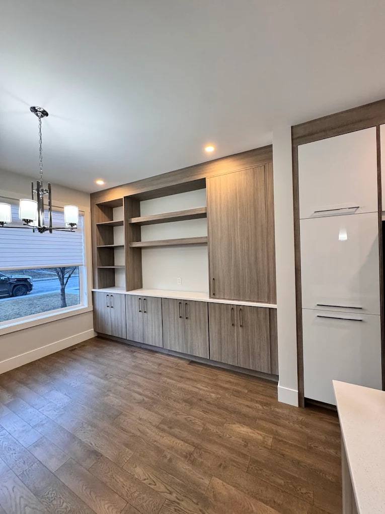 Dining room built-in with wood-finish cabinets, open shelving and a tall pantry cabinet