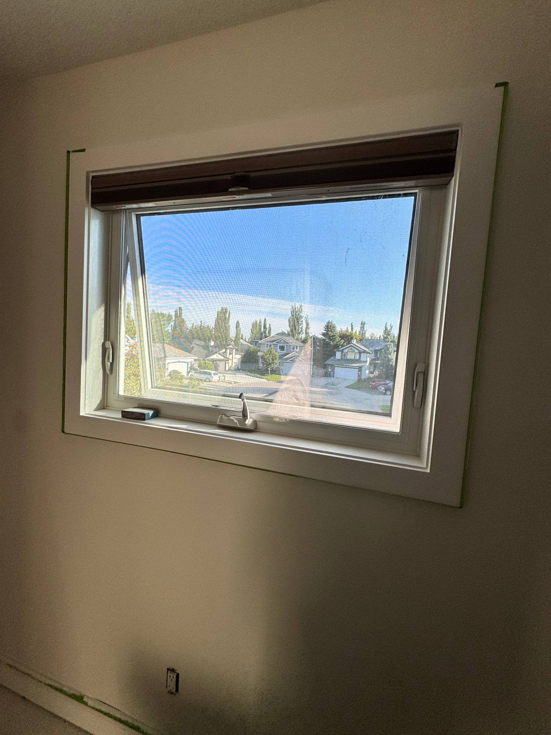 Window trimmed with new casing on all four sides, looking out over the neighbourhood
